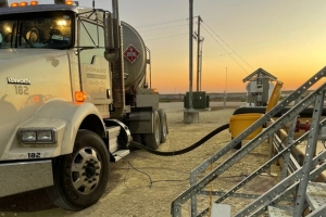 Fuel truck refueling equipment at sunrise.